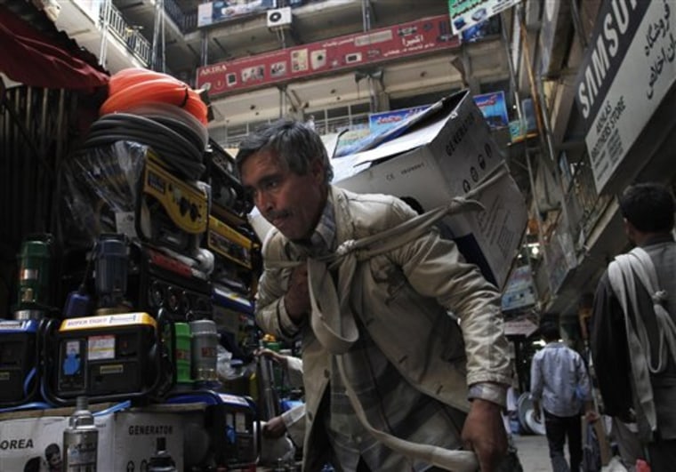 In this June 23, 2010 photo, a man carries an appliance he bough at Nader Pashtun market in Kabul, Afghanistan, where virtually everything comes from China. While the headlines focus on the U.S.-led war against the Taliban, China's spreading global footprint has become highly visible in Afghanistan, and the U.S. is said to welcome it. (AP Photo/Musadeq Sadeq)